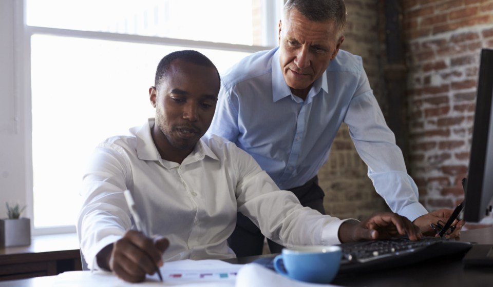 Businessmen Working On Computer In Office